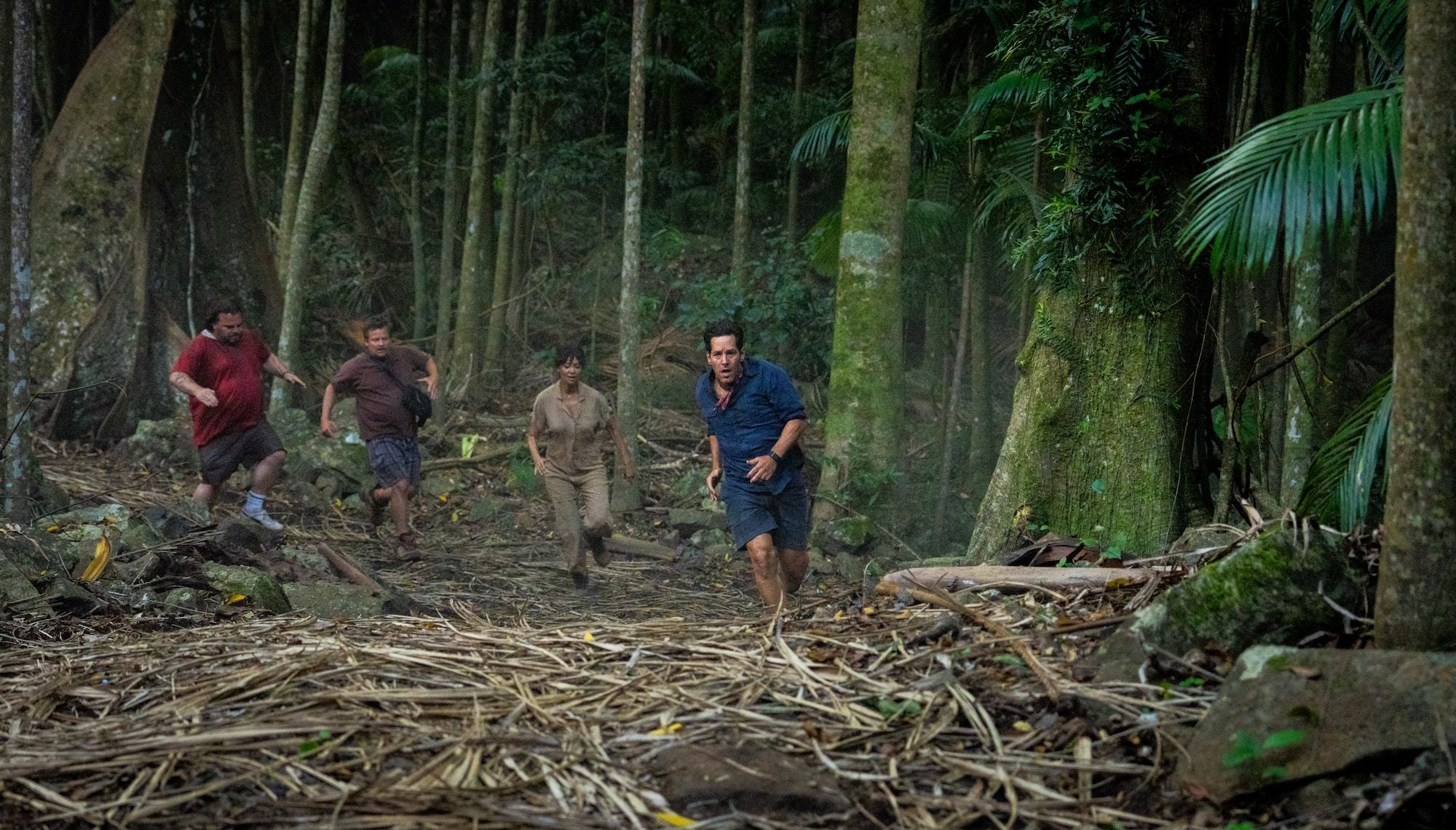 Four people running through the jungle in the film Anaconda