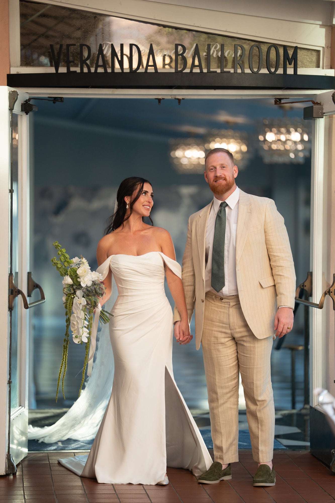 Bride and groom walking into Veranda Ballroom
