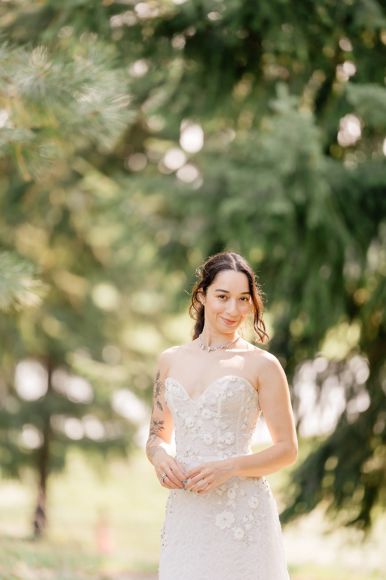 Portrait of bride standing in front of trees