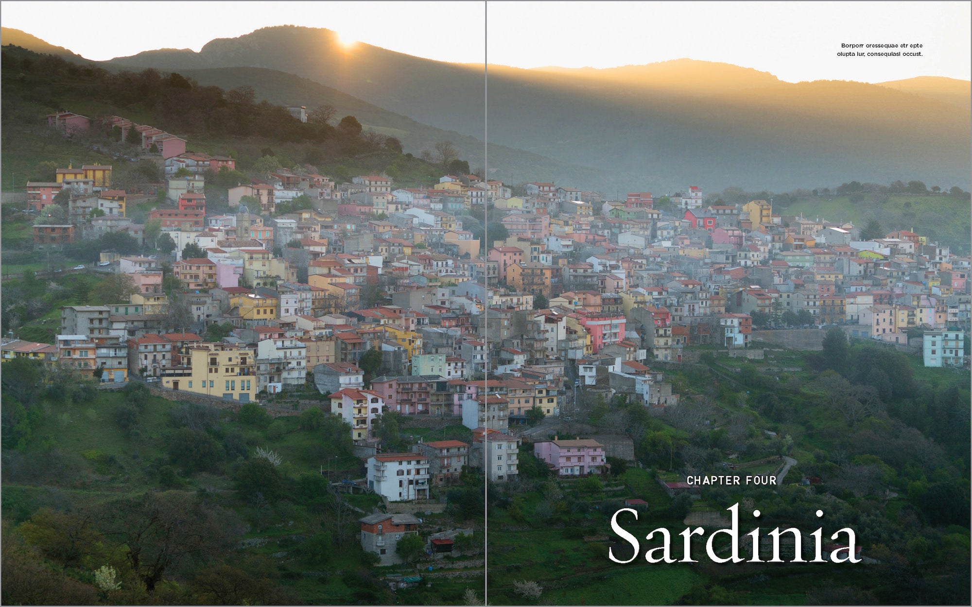 Sunrise over a hillside village in Sardinia with colorful houses nestled in green valleys.